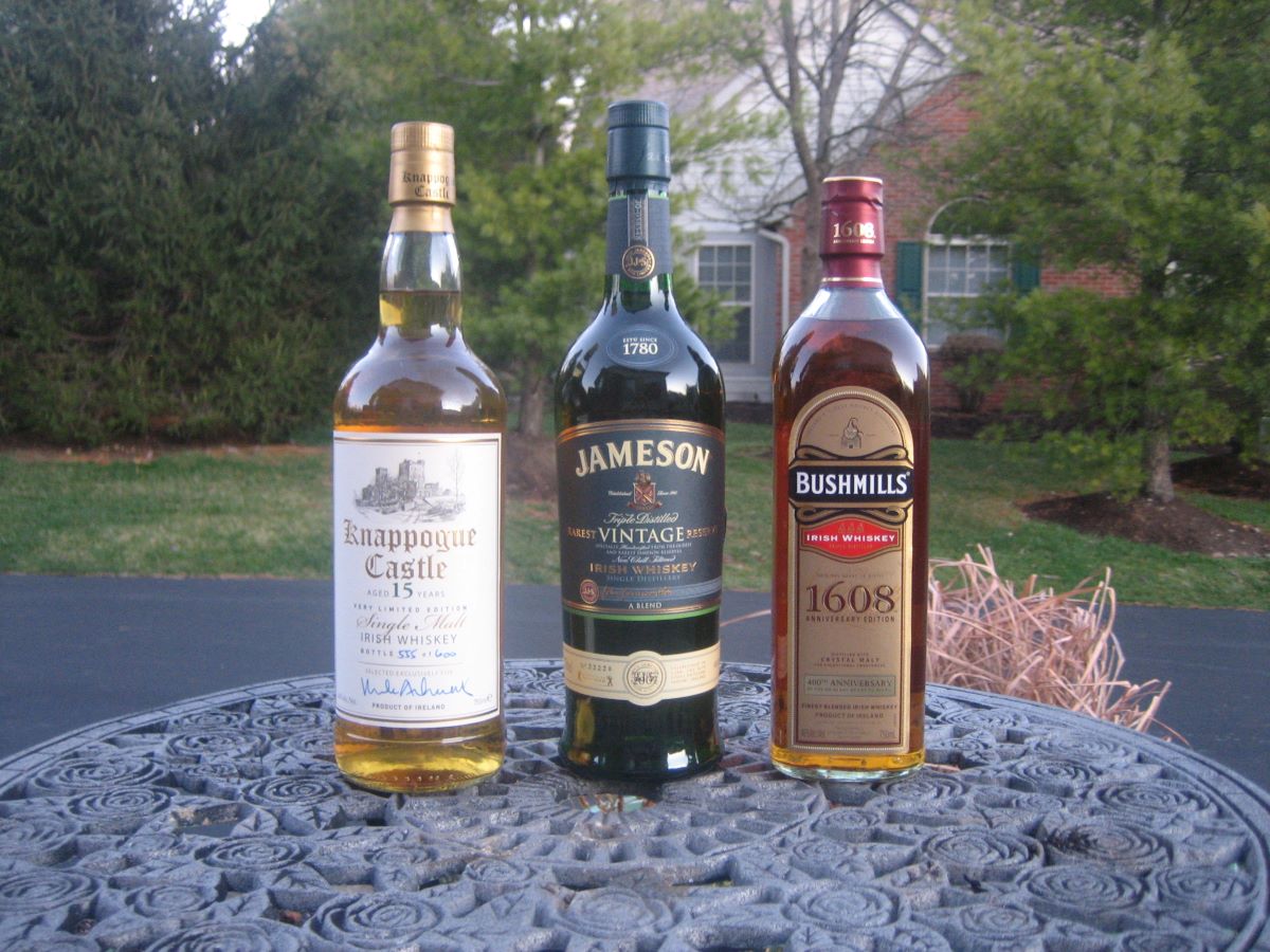 Three bottles of Irish whiskeys on a round table