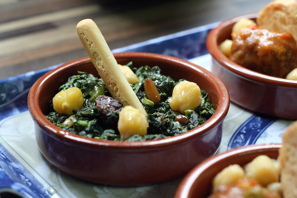 Garbanzos con espinacas (chickpeas and spinach) is one of our favorite tapas in our vegetarian guide to Seville!