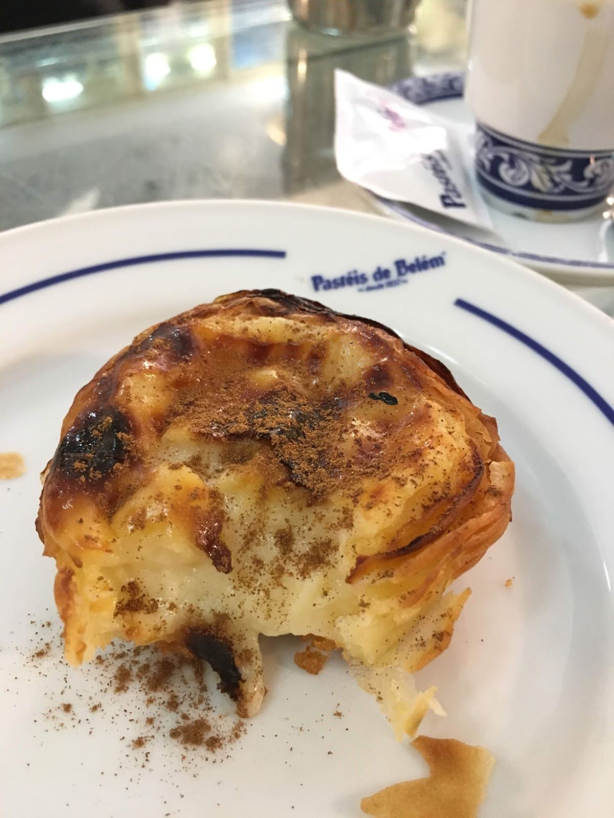 a bite taken out of a custard tart at Pastéis de Belém in Lisbon. 
