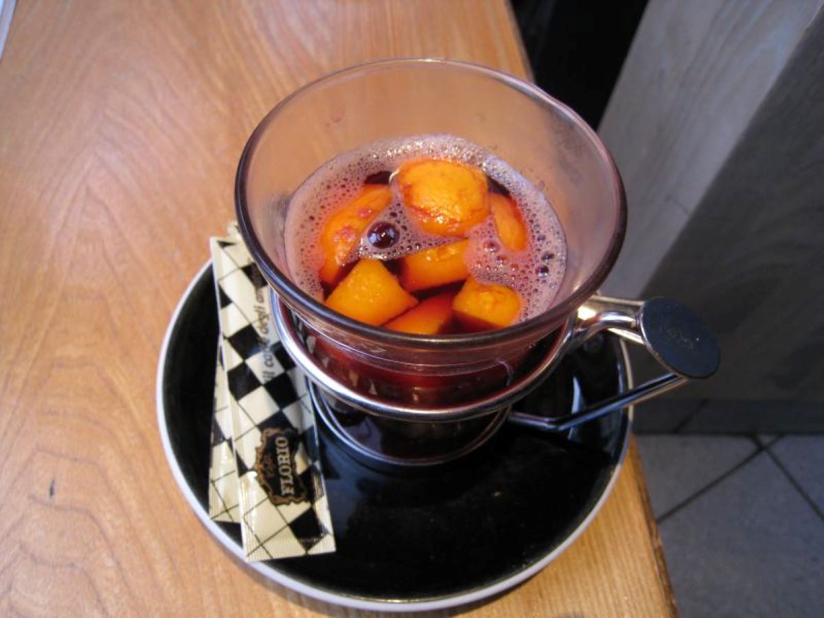 Close up of fruit in hot mulled wine at a restaurant in Paris during the Christmas season.. 