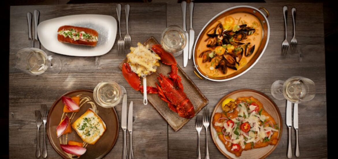 a table with five very colorful seafood plates