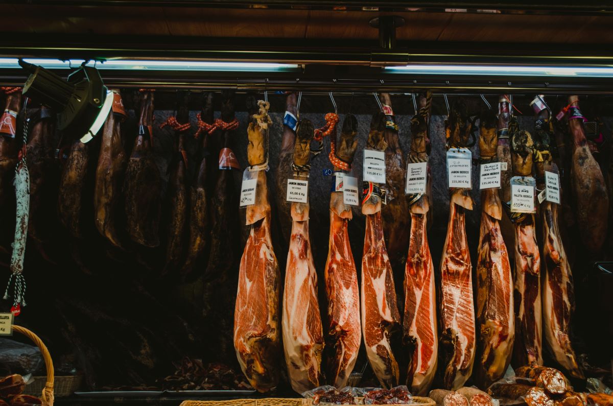 Legs of jamon hanging from a store front in Europe. 