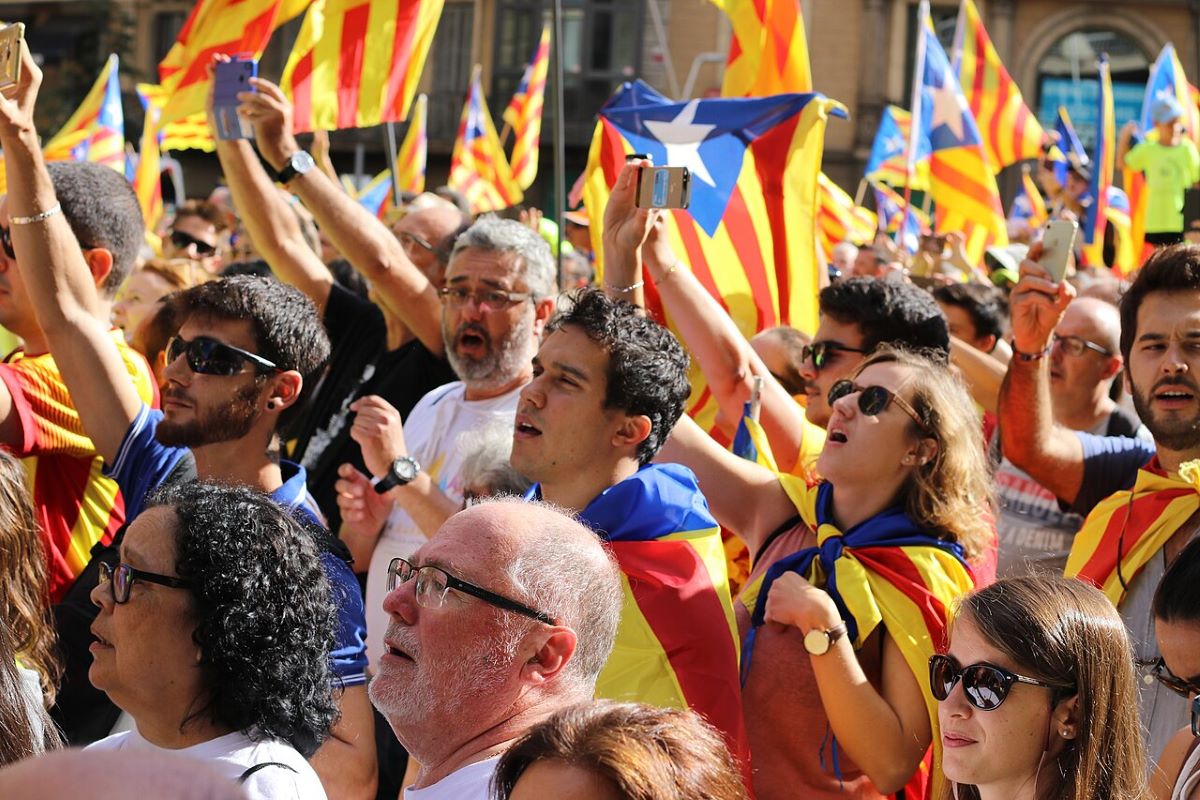 A large group of people celebrating La Diada in Catalan in Barcelona in September. 