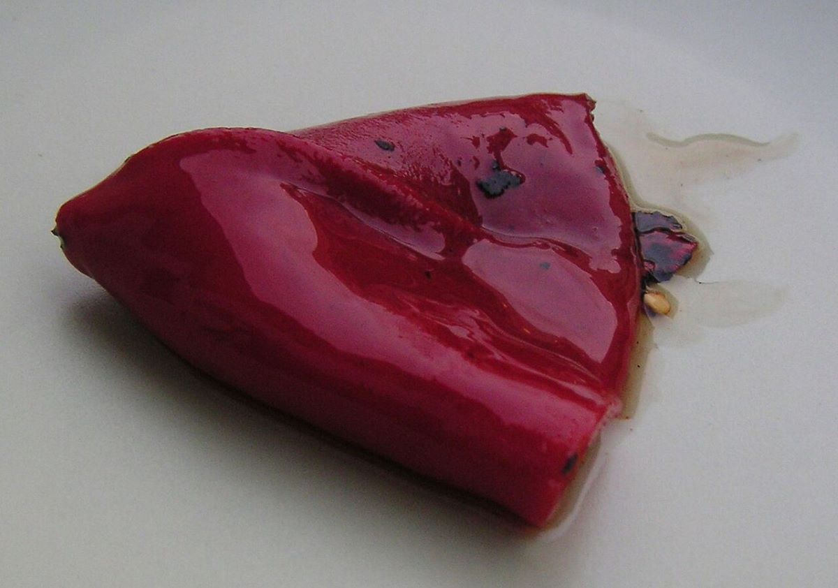 A piquillo pepper on a ceramic plate. 