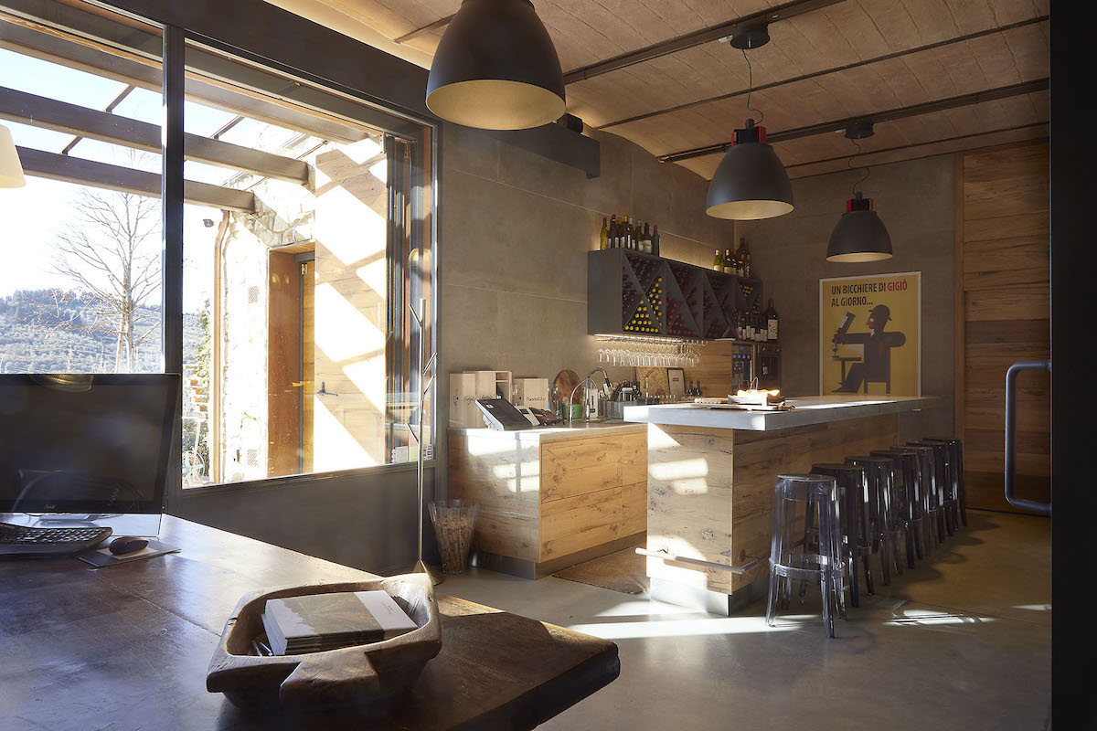 Wine tasting space with a bar and table decorated in neutral tones