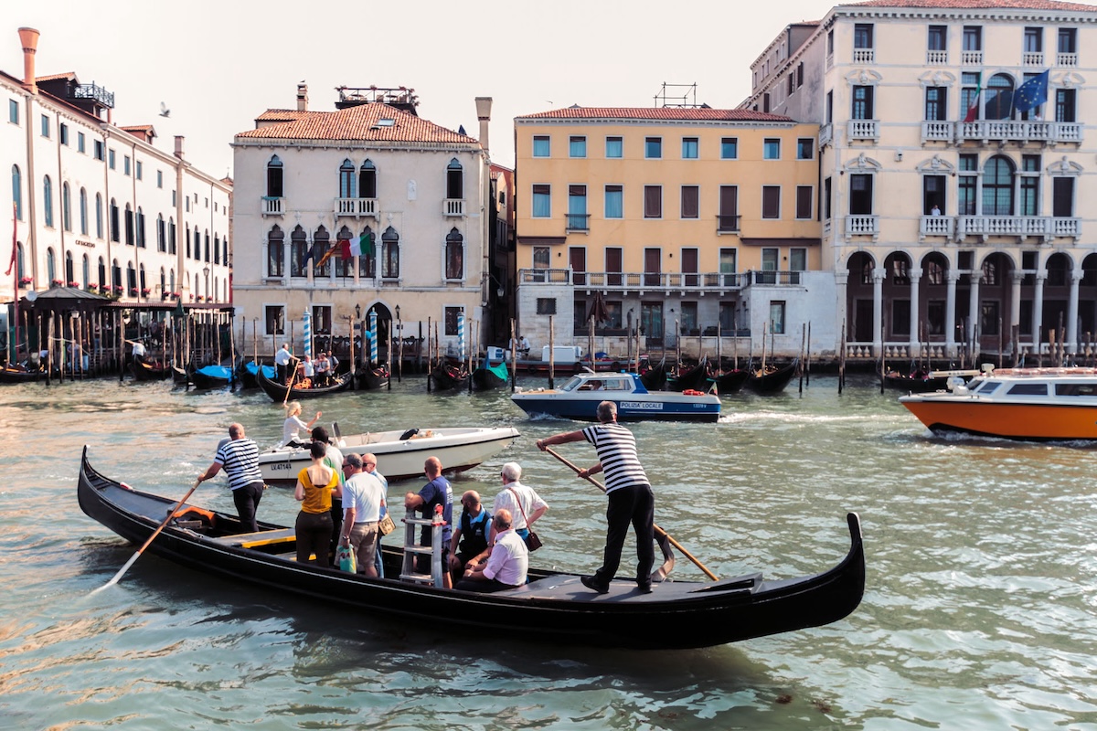various people enjoying a ride on a black gondola