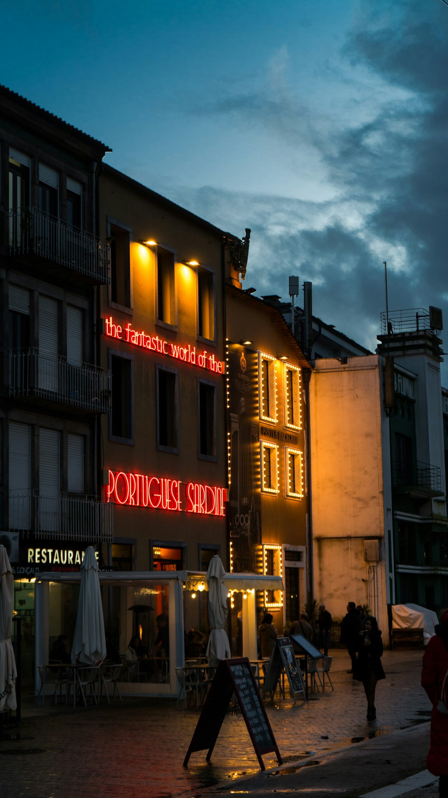 Building with a neon sign about sardines in Portugal