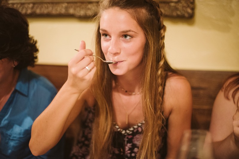 Girl tasting food on a spoon
