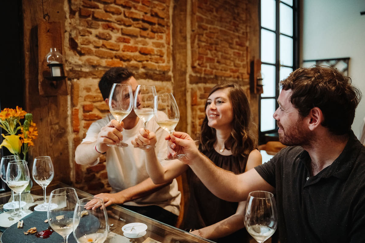 Toasting with white wine in a bar