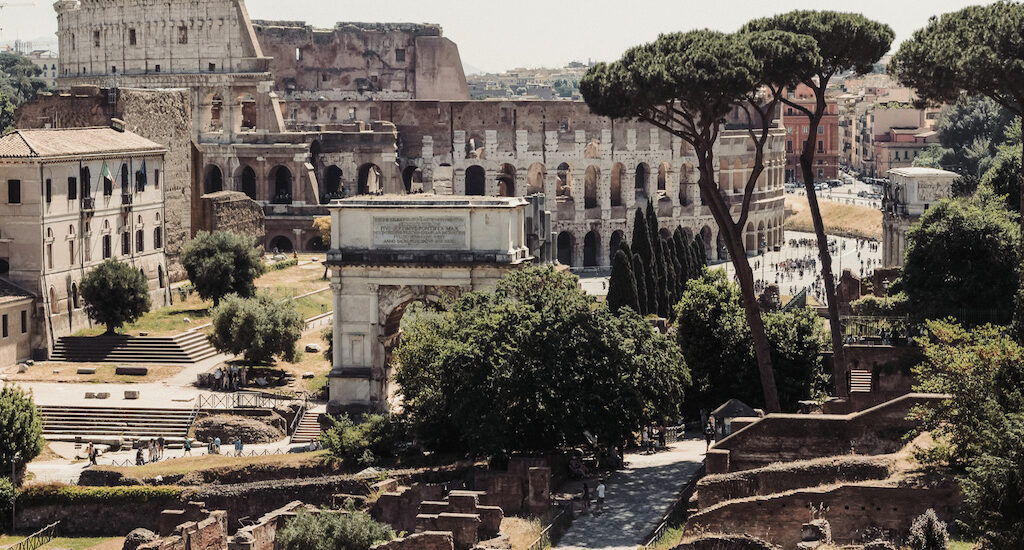 Colosseum and Roman Forum in the daytime with trees and plants