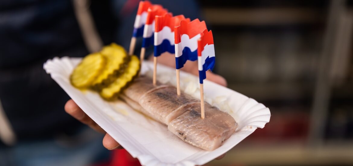 A person holding herring in Amsterdam.