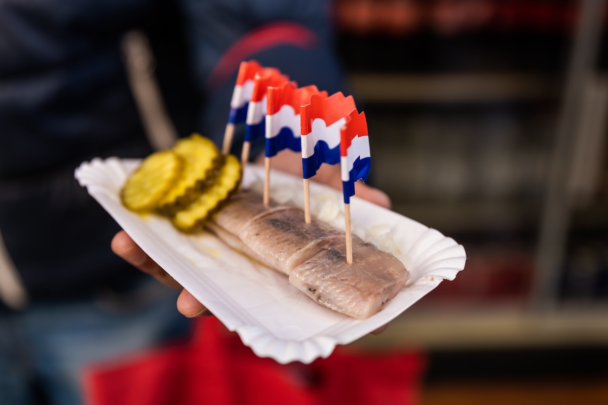 A person holding herring in Amsterdam.