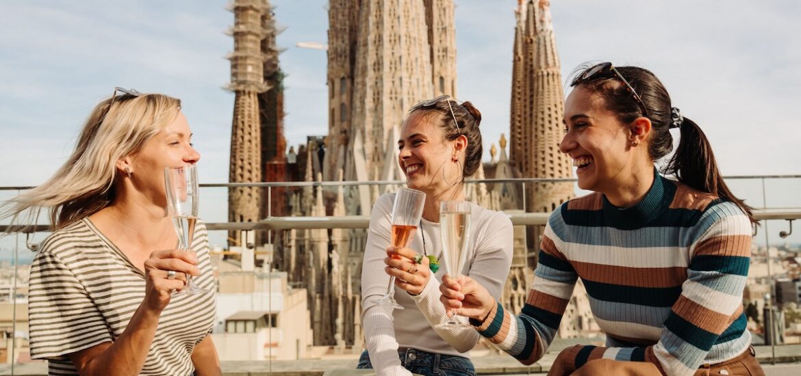 girls drinking cava with views of the sagrada familia church in the background in barcelona