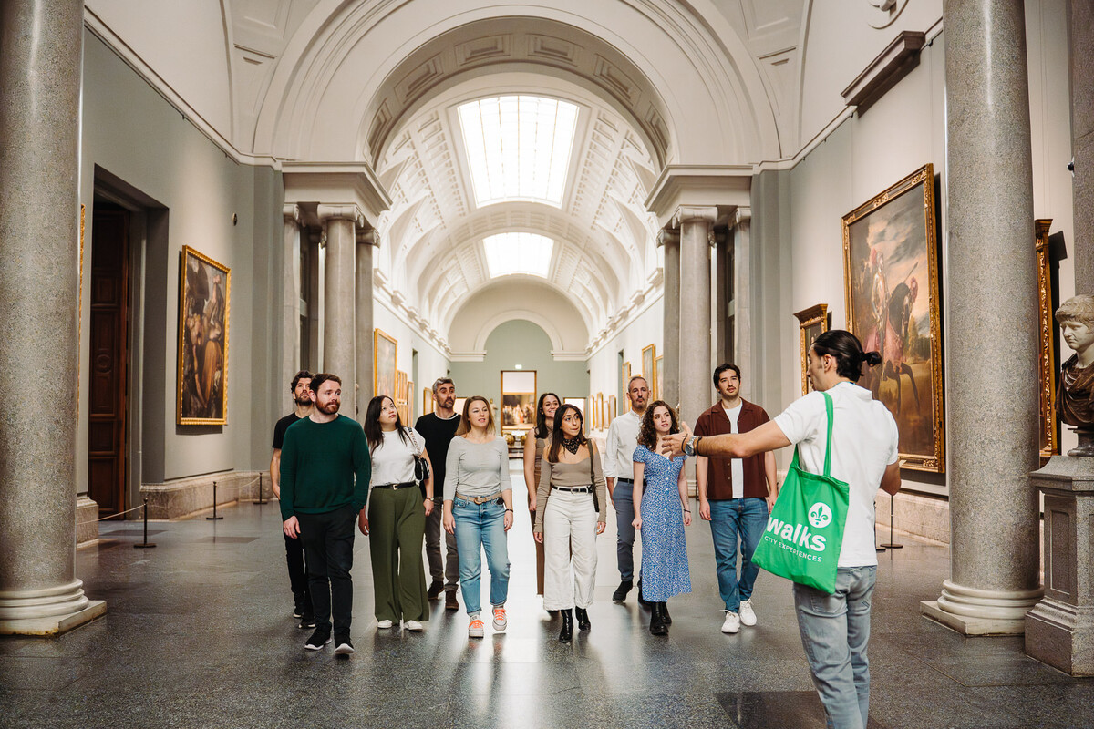 Walks tour guide leading guests on a VIP tour of the Prado with artwork on all sides