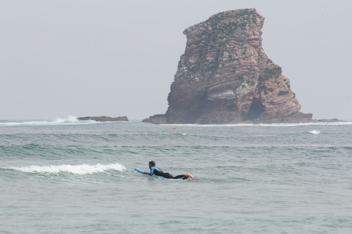 surfers in the sea waiting to catch waves on the French side. 