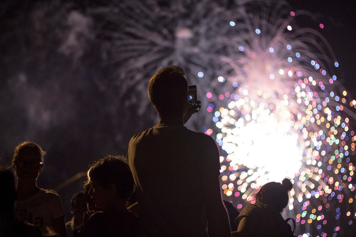 A group of people watching fireworks at Semana Grande in San Sebastian.