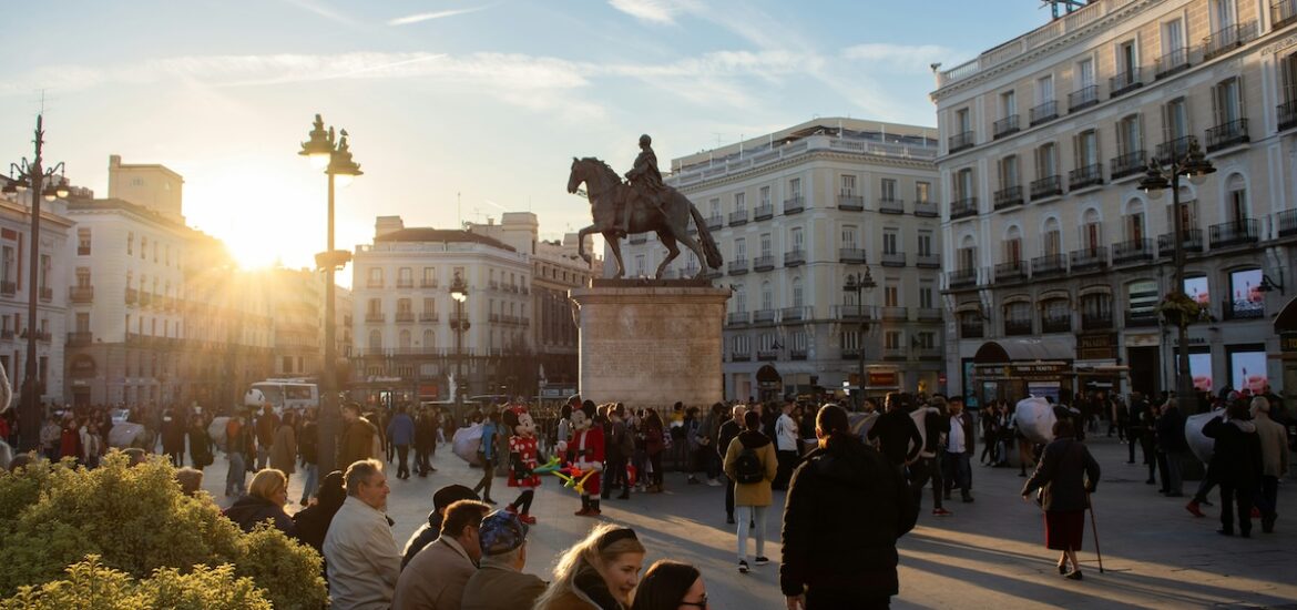 people sitting in a center square in Madrid