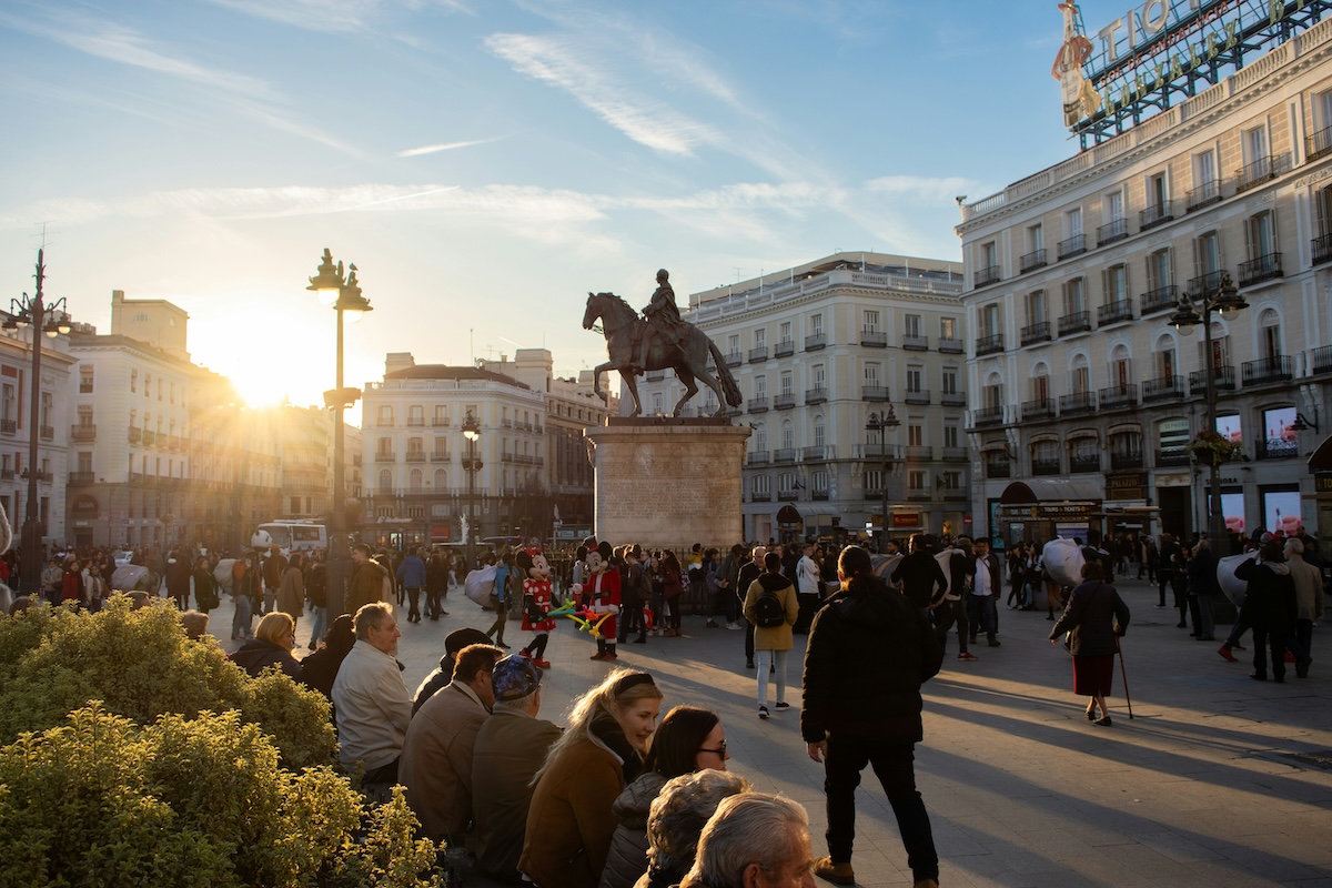 people sitting in a center square in Madrid