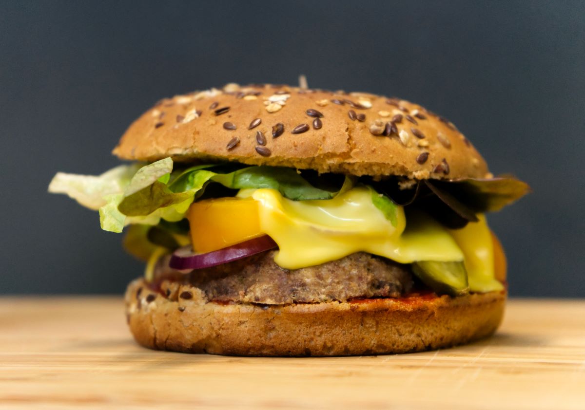 veggie burger with pepper, onion, lettuce and cheese