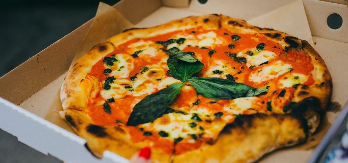 Minimalistic, fresh-baked pizza from Naples with tomato sauce, cheese, and basil