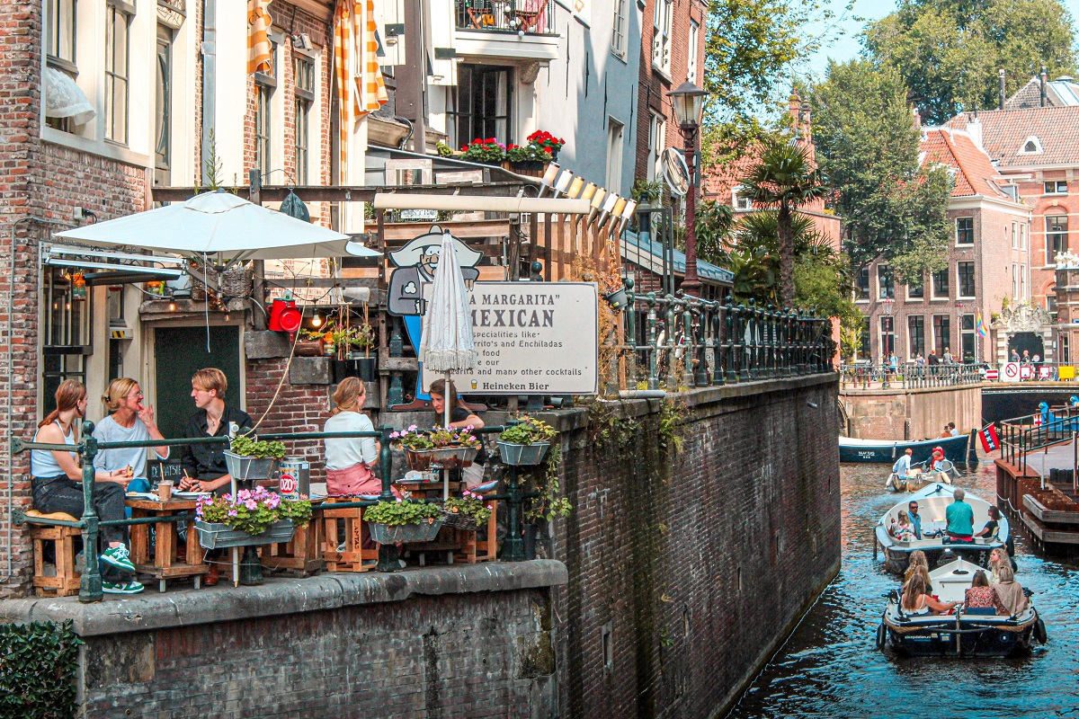 eating outside at a canal at one of the best restaurants in amsterdam