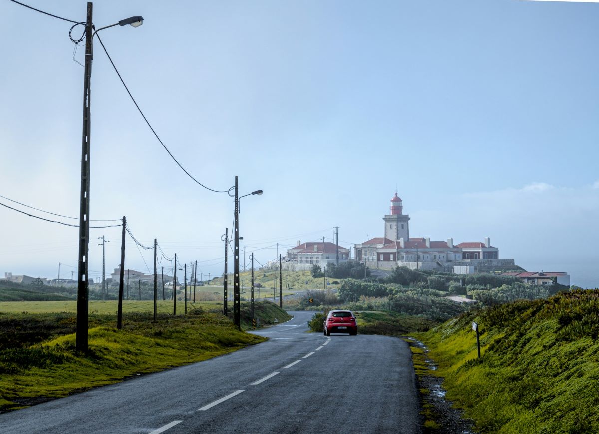 A car on a road driving to Cabo da Roca. 