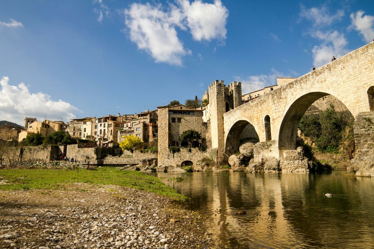 People walking around the medieval town in Besalu, Spain. 