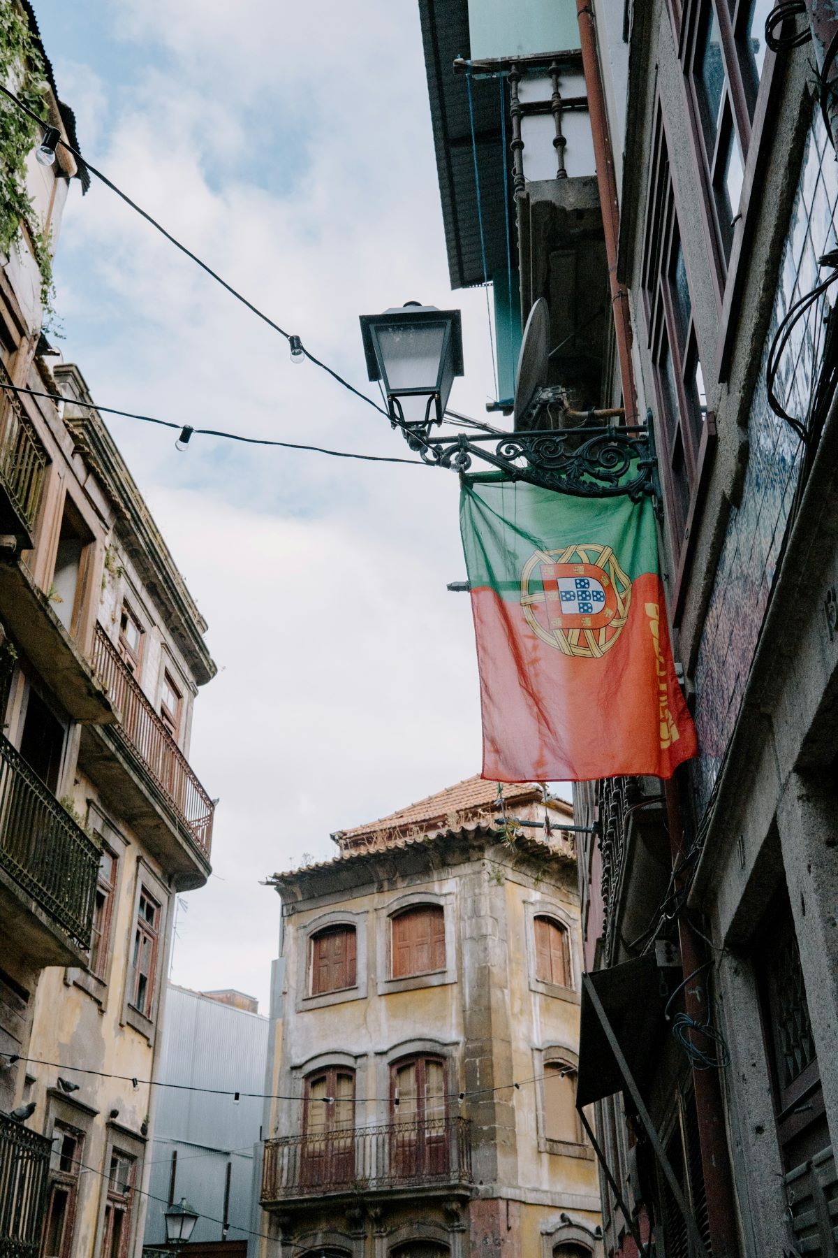 A Portuguese flag hung outside of someones apartment. 