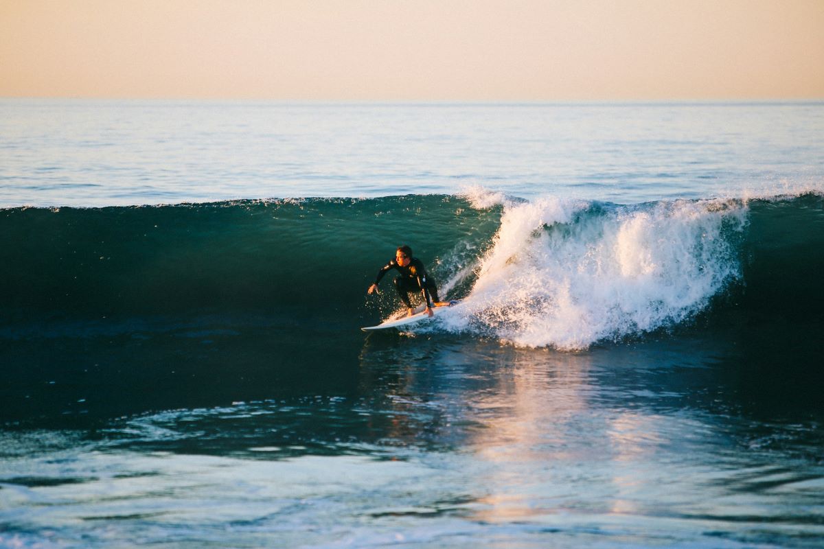 surfer catching a wave surfing in San Sebastian