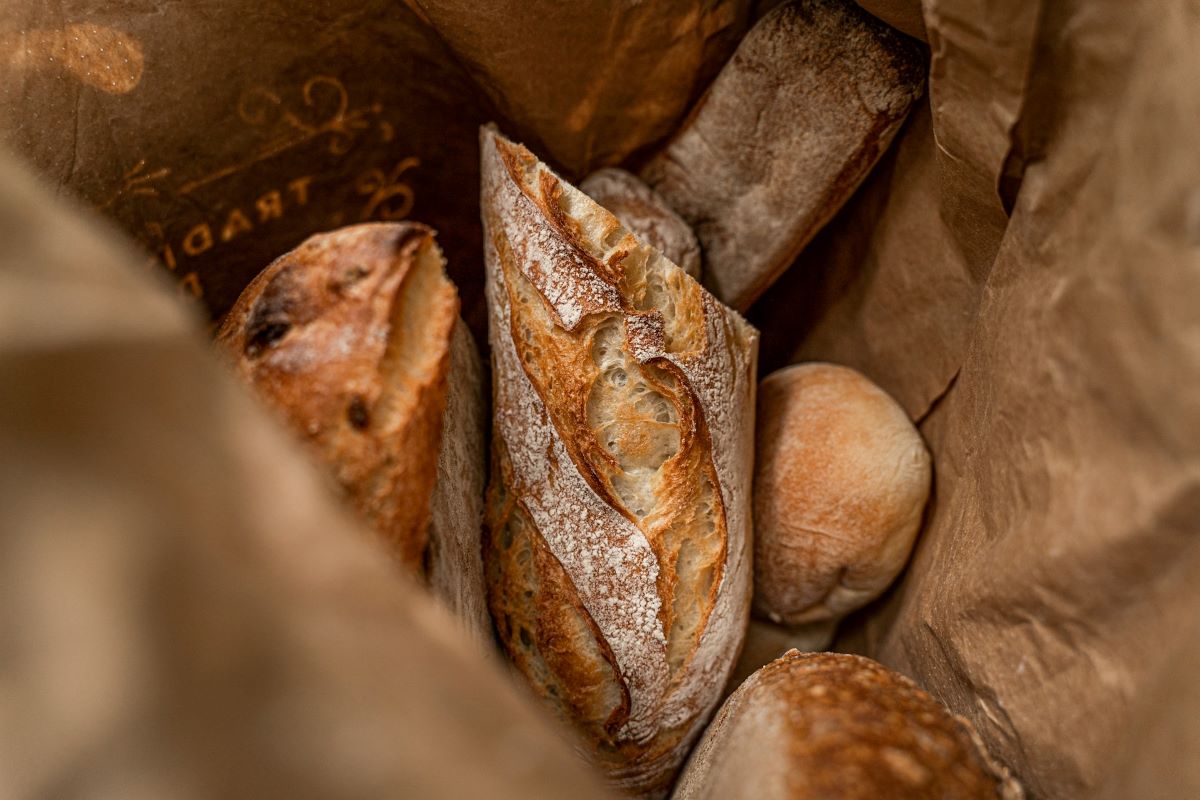 bread from a french bakery in a brown paper bag.