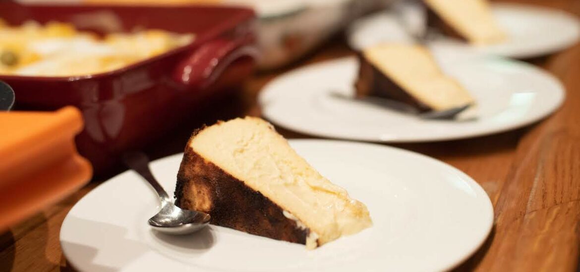 Plates of creamy cheesecake on a wooden surface