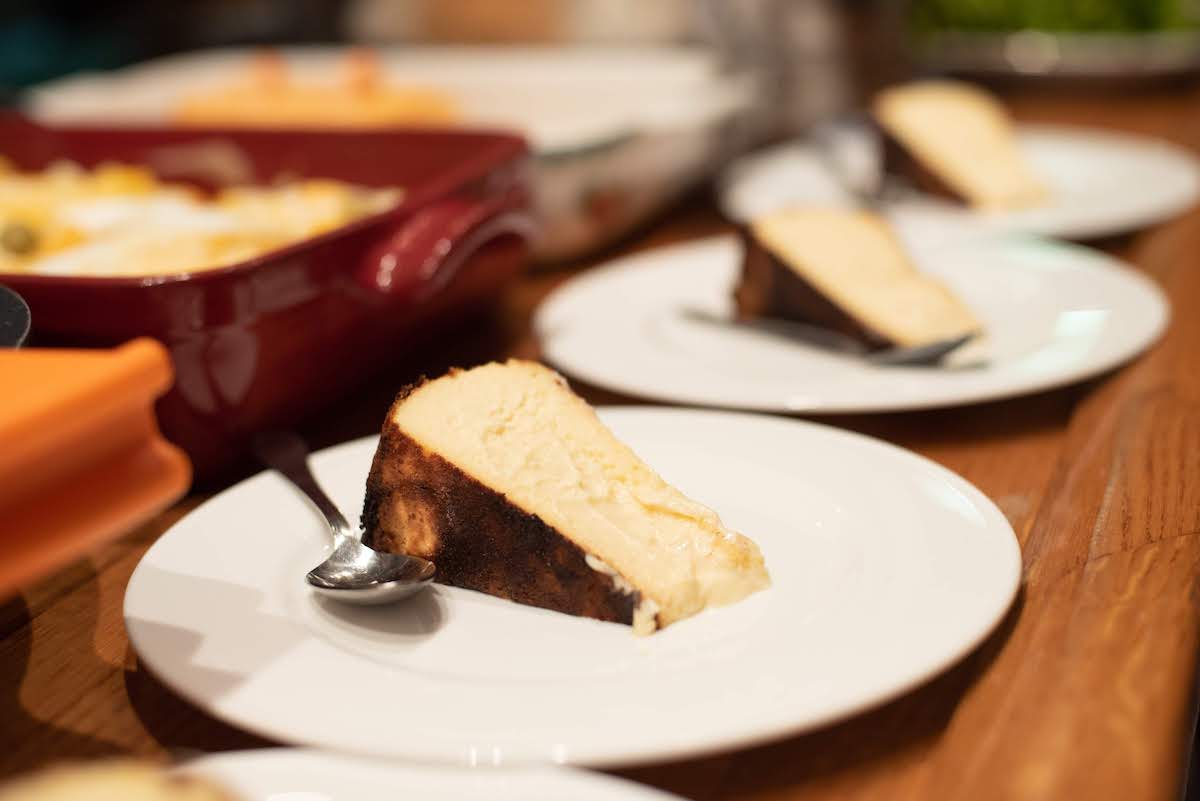 Plates of creamy cheesecake on a wooden surface