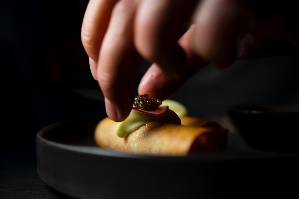 Carefully constructing a dish at a michelin starred restaurants in italy