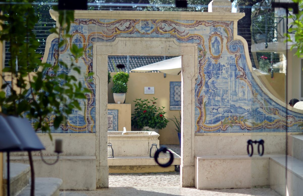 hidden garden at budget friendly hotel in Lisbon with marble tile arches. 