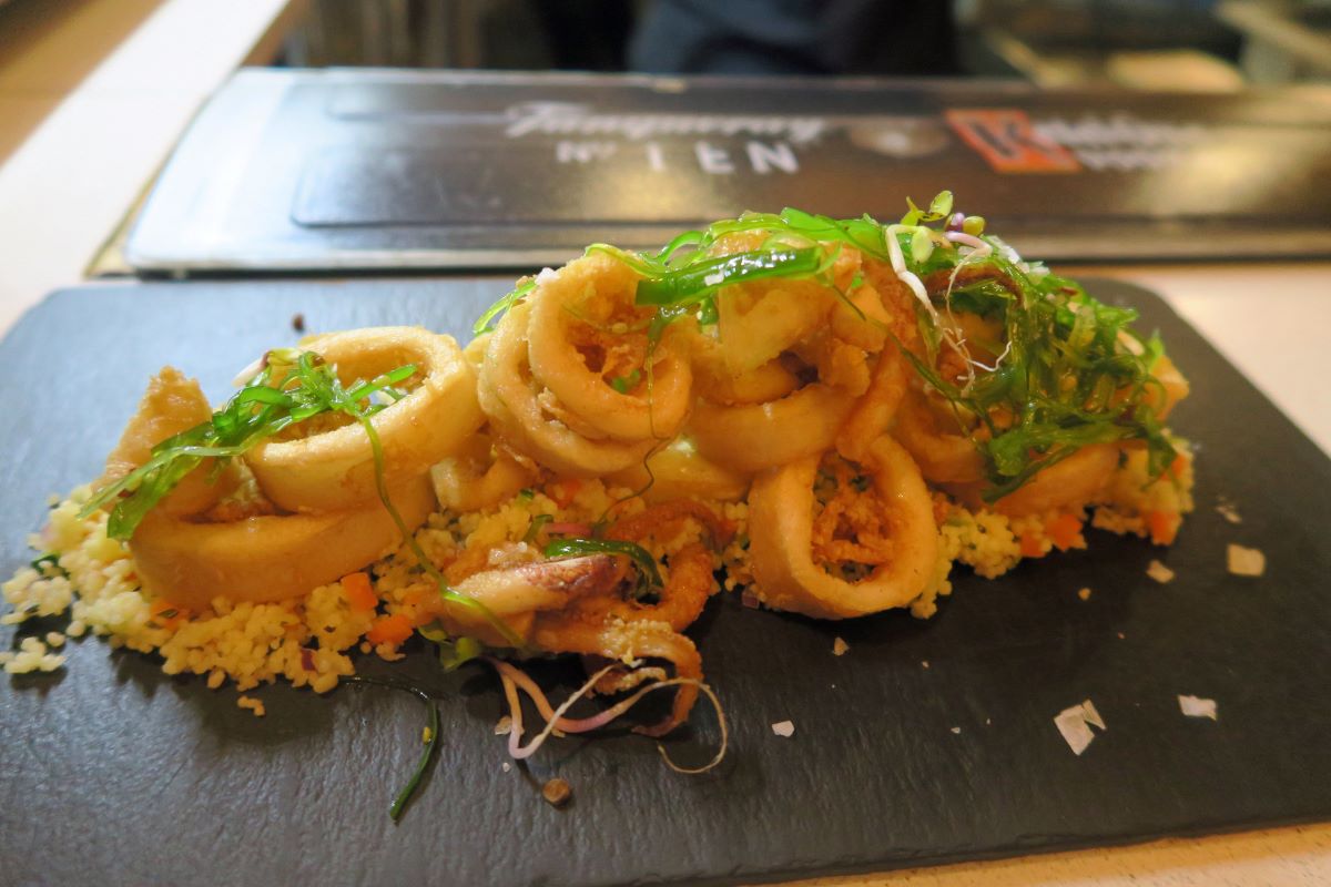 a flat black plate topped with fried calamares