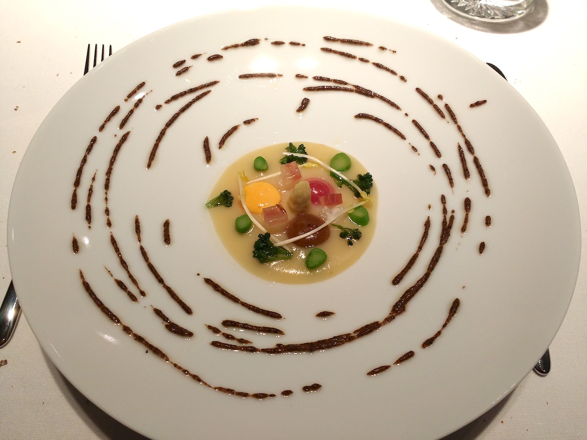 Modern presentation of a vegetable dish with truffle oil at a Michelin star restaurant in Madrid