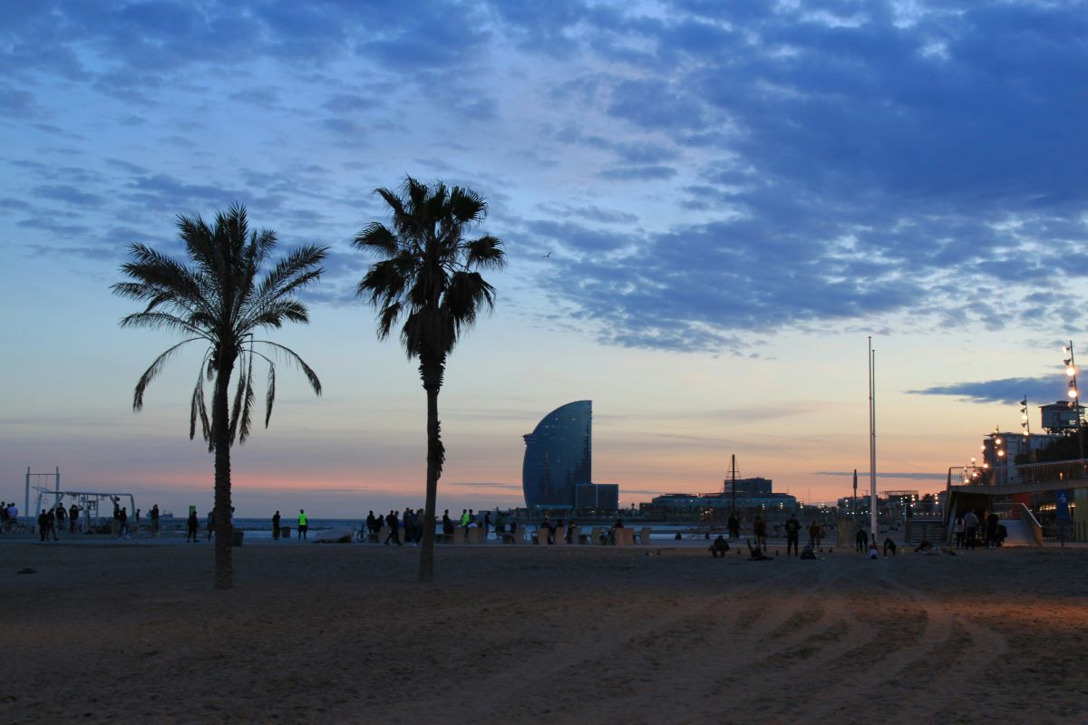 sun setting on beach in barcelona