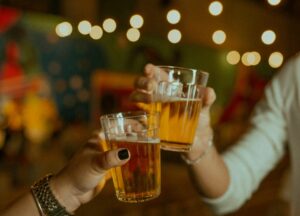 two people holding beer to do a cheers