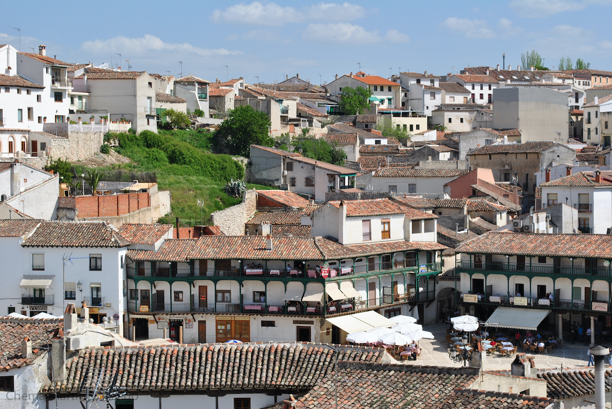 A small Spanish town with dozens of whitewashed houses.