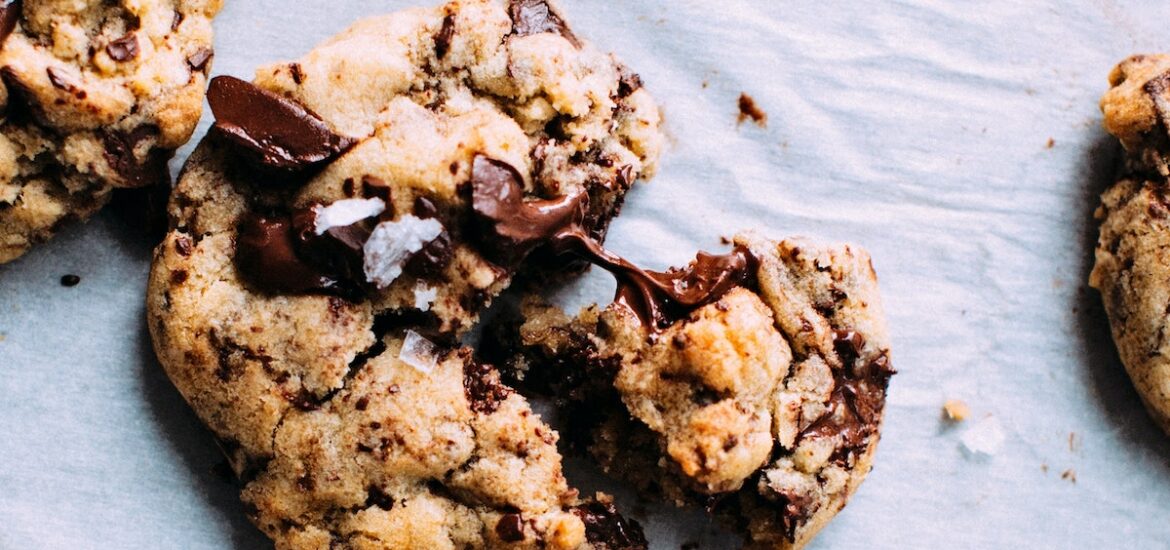 Overhead shot of chocolate chip cookies on white parchment paper