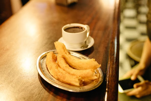 Churros and chocolate on a bar