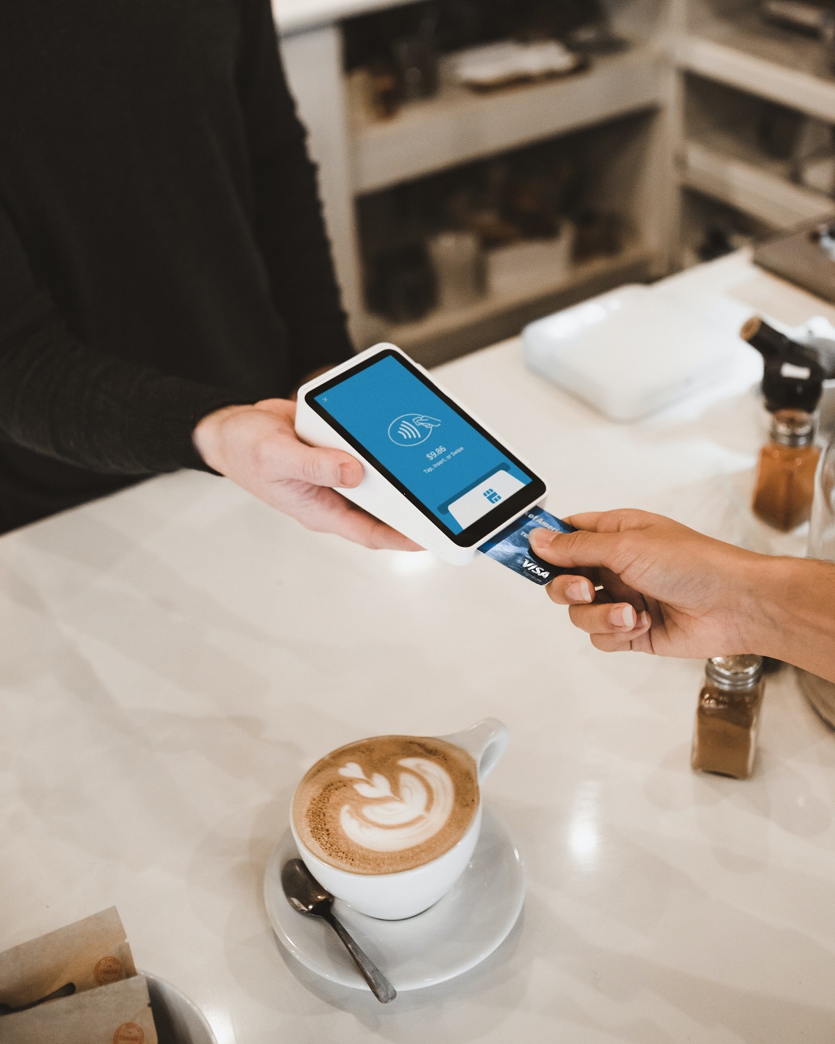 Customer paying by credit card at a POS machine