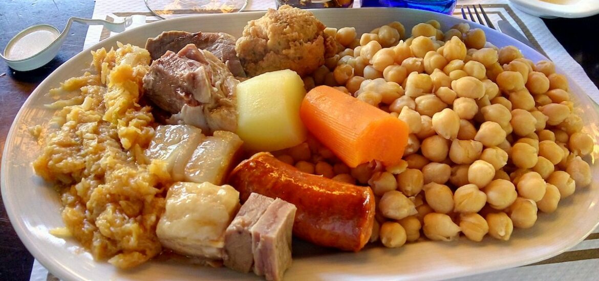 Large plate full of chickpeas, meats, and vegetables