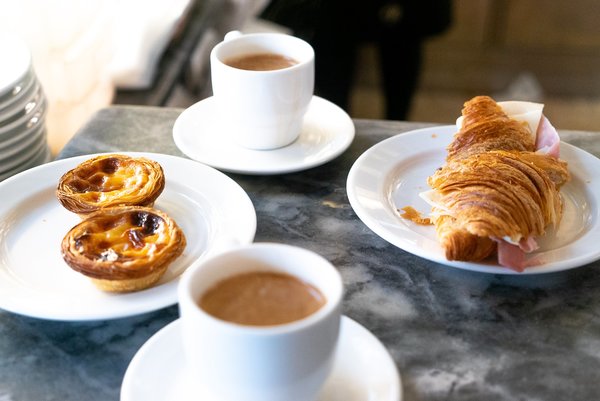 Coffee, custard tarts and a croissant sandwich