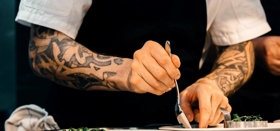 NYC chefs plating food in busy diner.