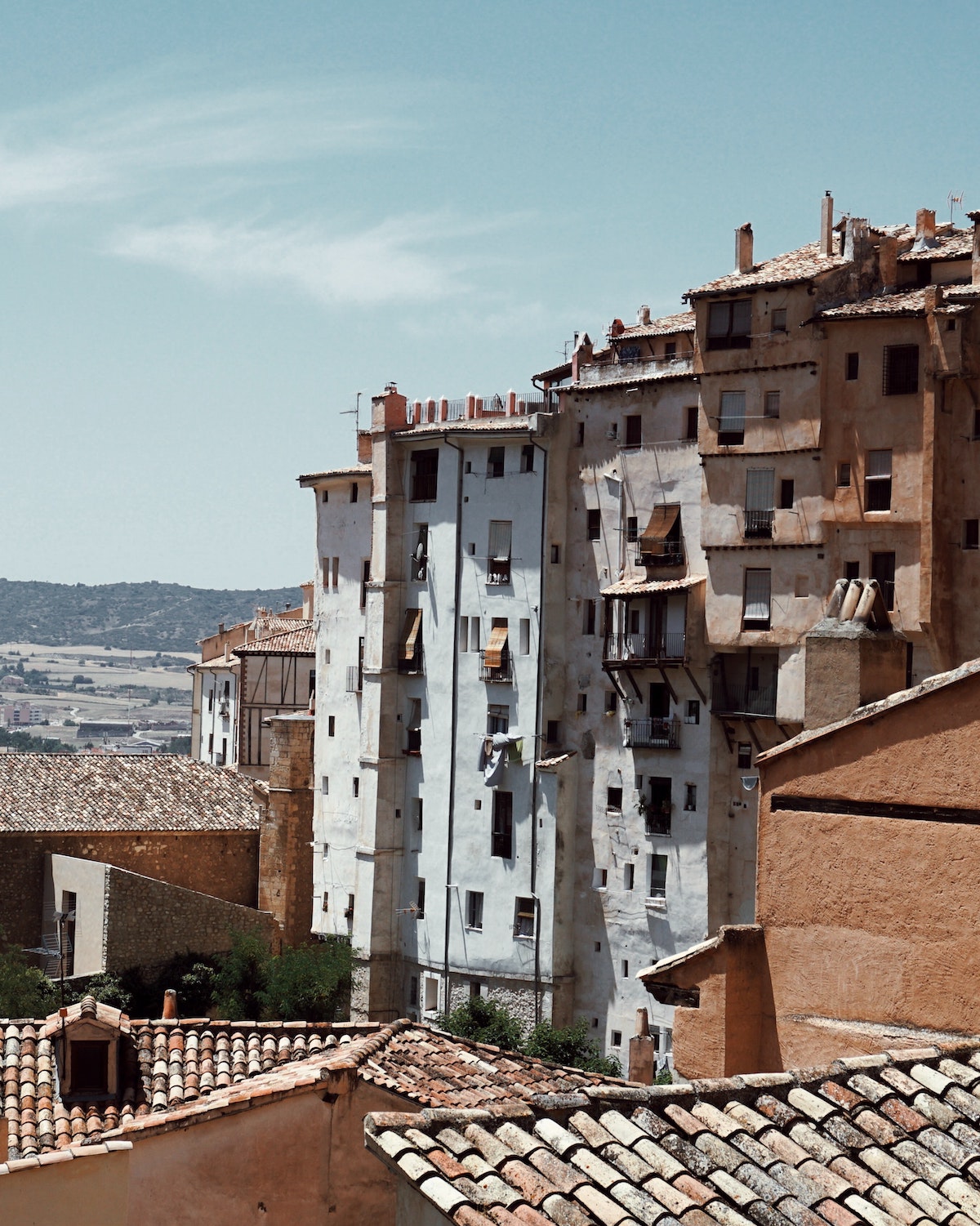 White and brown concrete buildings in a small Spanish town.