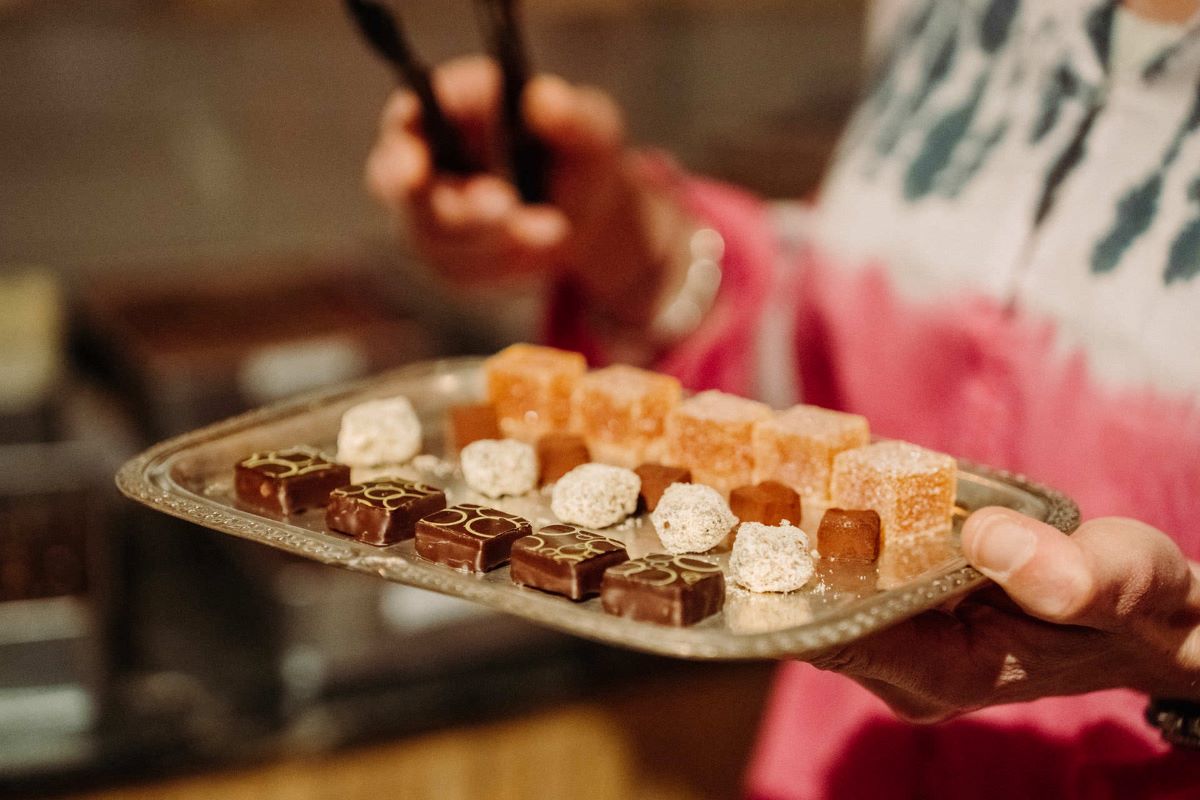 A small tray of sweets including chocolates and other confections.