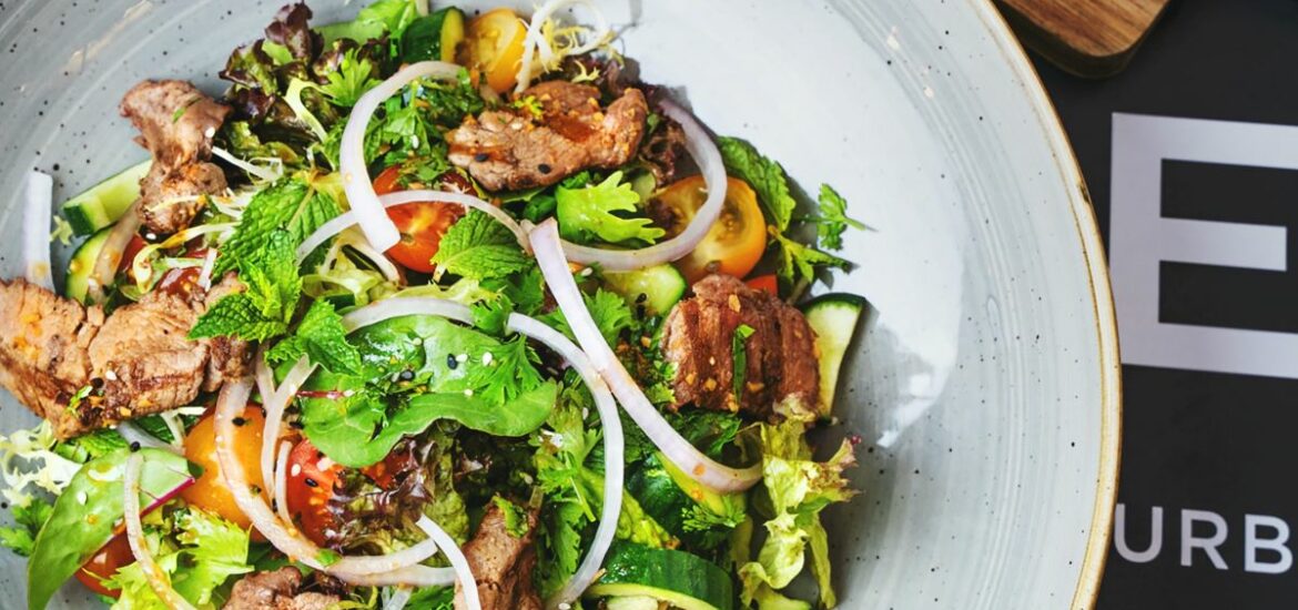 salad with meat strips and fresh juice