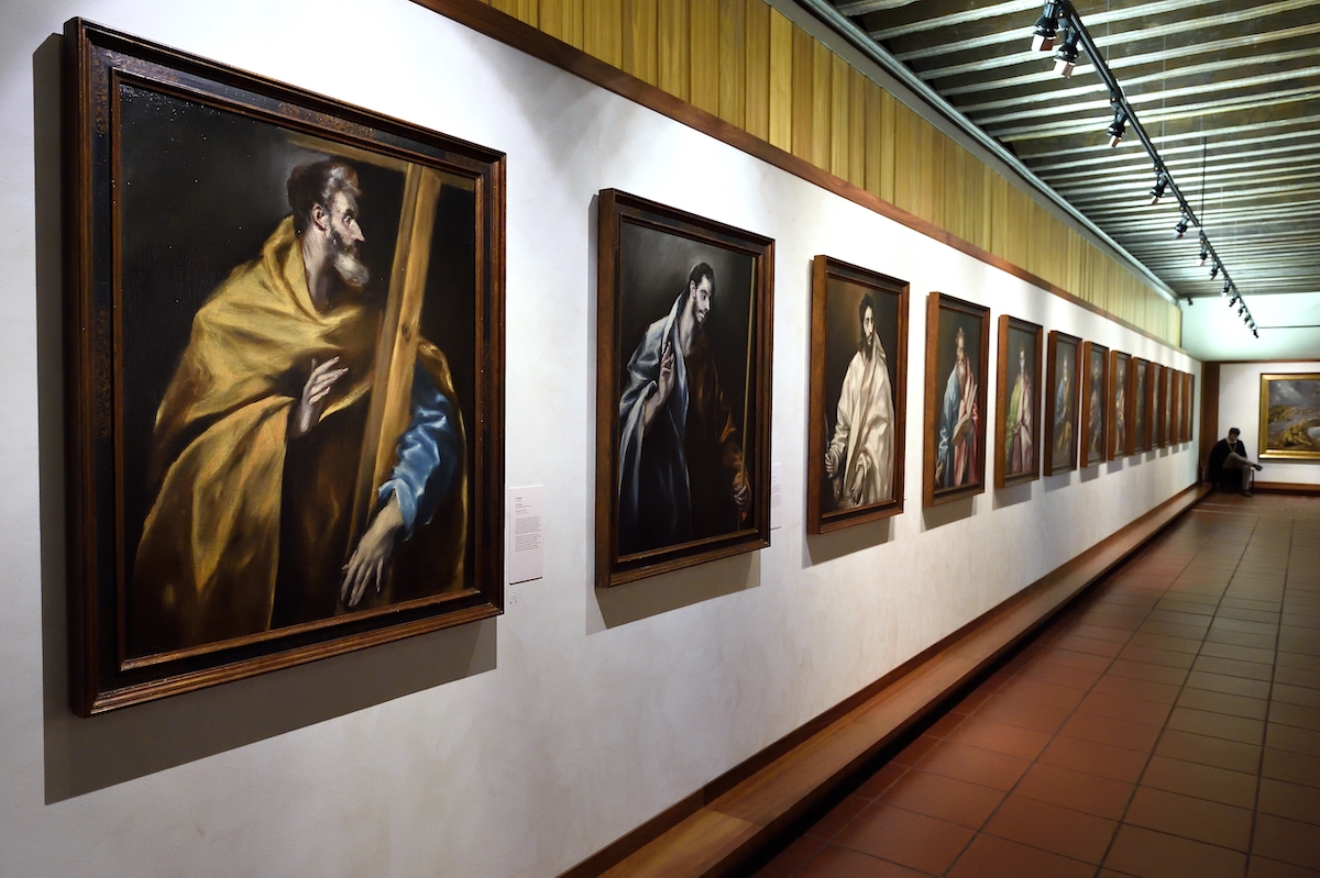 Set of portraits of religious figures hanging on a white wall.