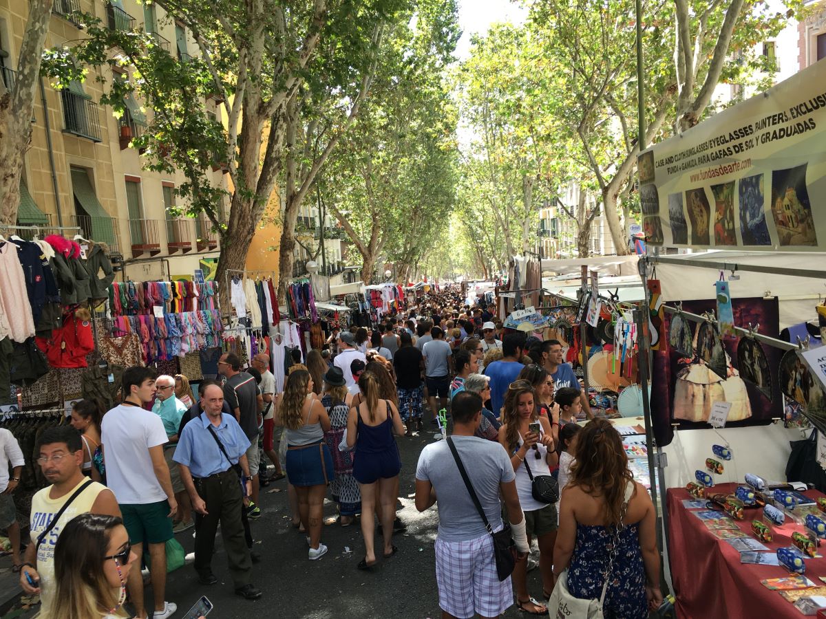 people walking around a flea market